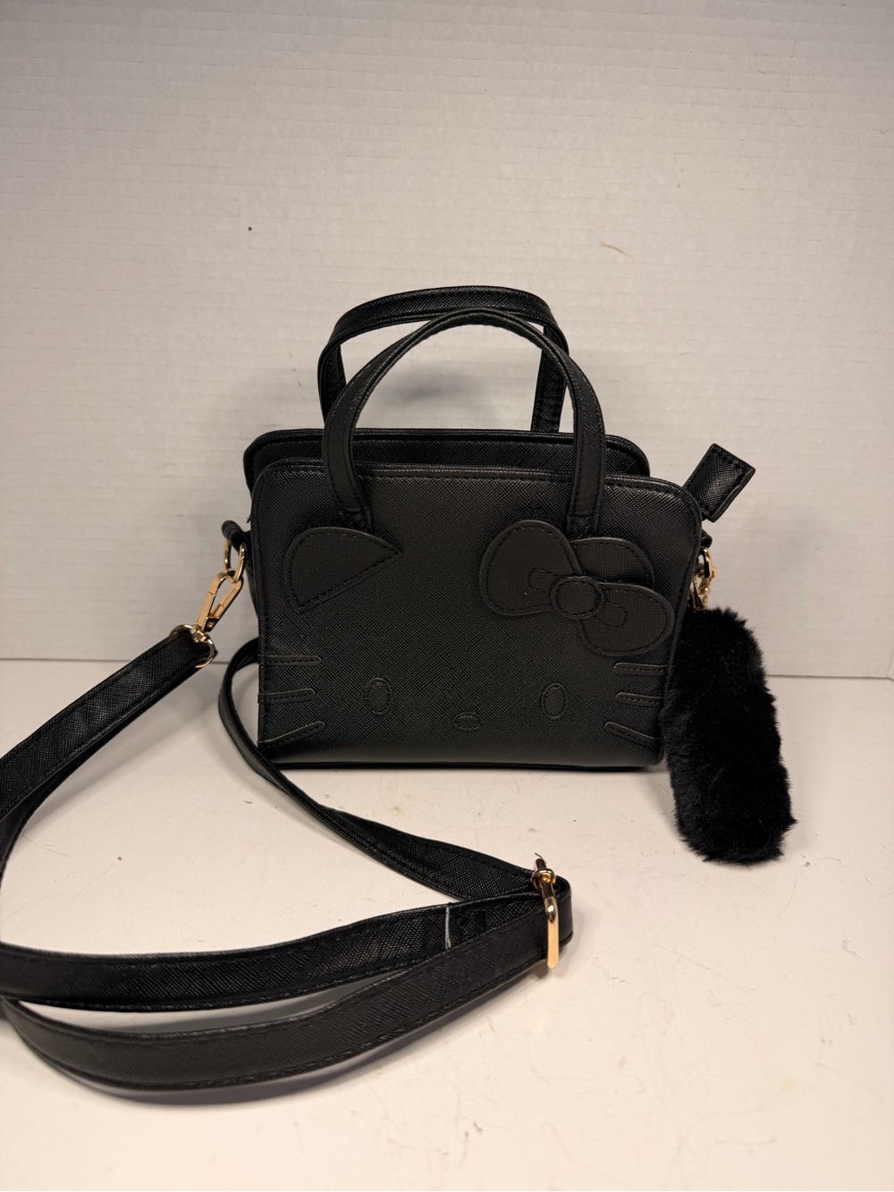 Sanrio Hello Kitty Black Faux Leather Crossbody Handbag with Pom Pom Charm